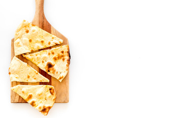 Make focaccia. Traditional italian bread on cutting board on white table top-down copy space