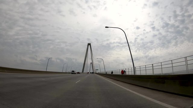 CHARLESTON, SC - APRIL 7, 2018: City traffic along Ravenel Bridge as seen from moving car. The city attracts 10 million tourists annually