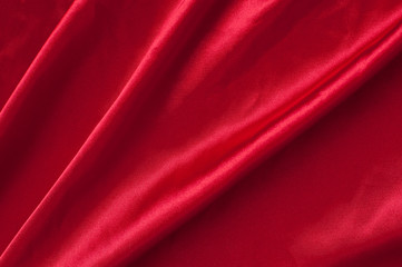 Naklejka na ściany i meble Folds of red satin fabric.