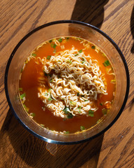 Packaged ramen noodle soup in sunlight
