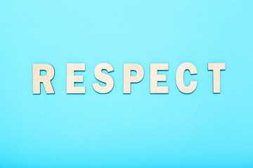 Word Respect by wooden letters on blue background