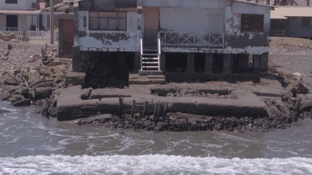 Aerial drone view move of an abandoned house on Colan Beach in Piura Region, Peru