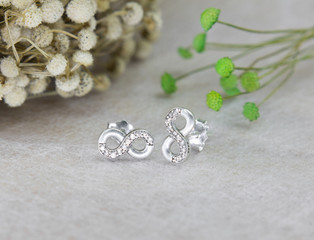A pair of beautiful diamond earrings in infinity shape