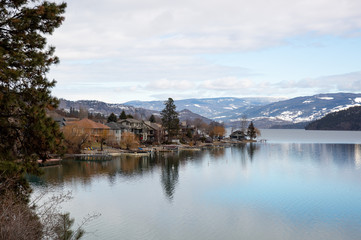 Fototapeta na wymiar View of town reflected in a lake. Lake Country, Okanagan, British Columbia