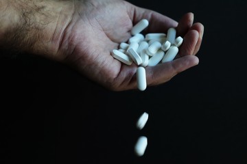 Medicine pills being thrown out by hand