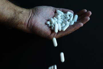Medicine pills being thrown out by hand