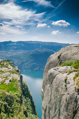 Fototapeta na wymiar view of the fjord. Two rocks over a cliff. Mountain lake and stone cliffs. Norwegian view from the mountain