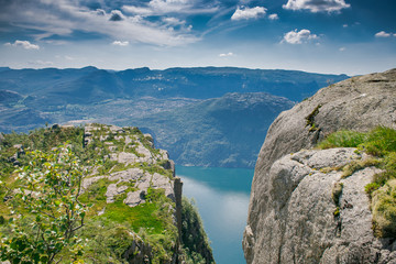 Fototapeta na wymiar view of the fjord. Two rocks over a cliff. Mountain lake and stone cliffs. Norwegian view from the mountain