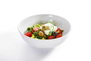 Greek salad in white bowl