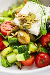 Greek salad in white bowl