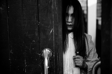 Portrait of asian woman make up ghost face with blood,Horror scene,Scary background,Halloween...