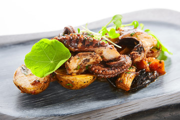 Grilled octopus with baked potatoes