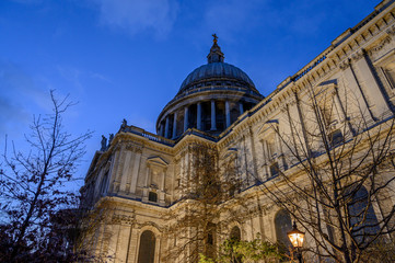 Fototapeta na wymiar St. Paul's Cathedral in London, UK. Evening view of St Paul's taken from the southeast of the cathedral. Illuminated building, blue sky and clouds