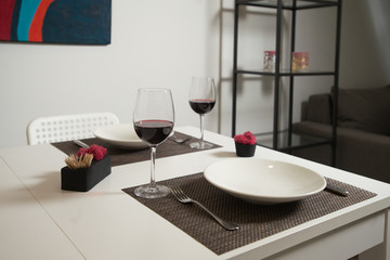 Glassware and cutlery for catered event dinner.