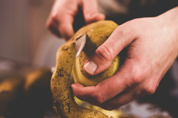 Peeling potatoes with a knife at home
