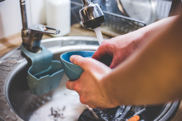 My dishes under running water with a paralon sponge