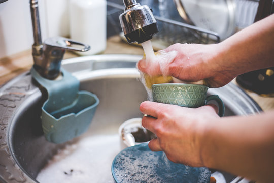 My dishes under running water with a paralon sponge