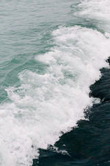 the sea wave arrives on the sandy shore . beautiful natural background