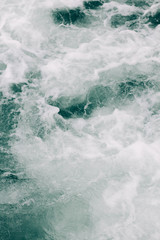 seething sea foam from a wave that broke on a rock. natural sea background