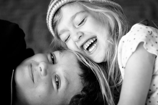 Adoring Little Sister Laughing With Her Brother
