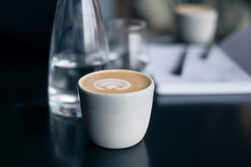 Cup of coffee on table in cafe