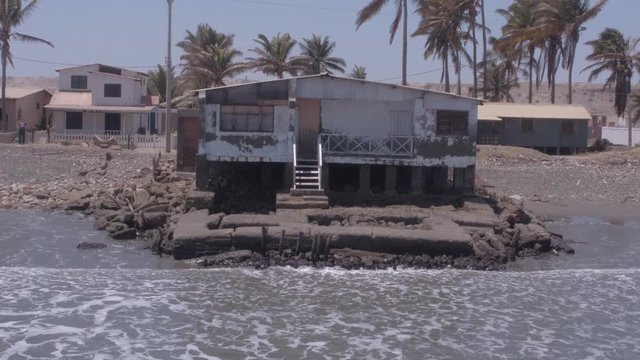 Aerial drone view move of an abandoned house on Colan Beach in Piura Region, Peru