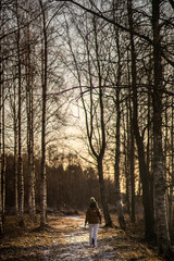 A woman walking in the forest. 