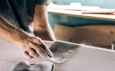 Anonymous shaper making a surfboard