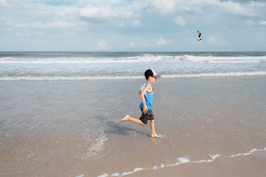 boy runs on beach
