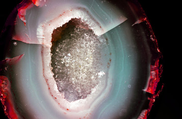Geology of beauty. Texture of gemstone clear agate closeup as a part of cluster geode filled with rock Quartz crystals.