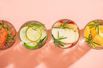 Glasses of detox water with sliced fruit.