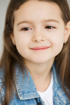 Portrait of a c little cute girl with dark long hair
