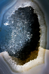 Geology of beauty. Texture of gemstone clear agate closeup as a part of cluster geode filled with...