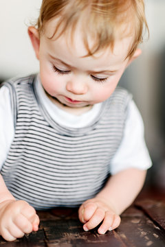Concentrating baby using pincher motion to pick up food