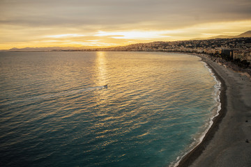 Nice in the evening after sunset. Panoramic view of Nice during sunset with mountains in the background.