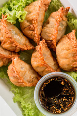 gyoza empanada comida deliciosa asiatica y lechuga  desde arriba con salsa de anguila