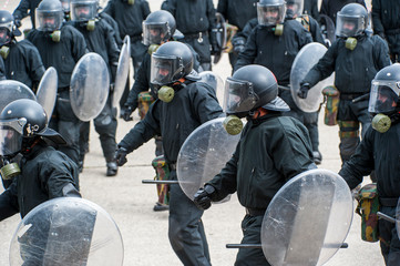 Leopoldsburg, Belgium. May 2011. Demonstration of riot squad forming a protective barrier with riot shields - obrazy, fototapety, plakaty