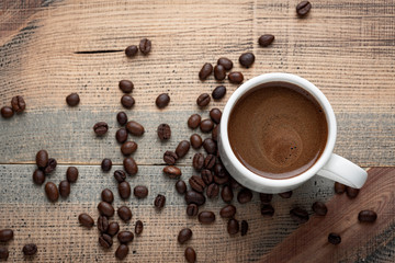  Cup of coffee and coffee beans on the table.