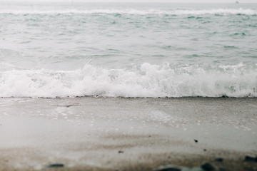 a sea wave arrives on the shore with black volcanic sand . beautiful natural background in Iceland