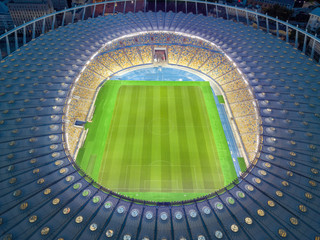 Night aerial drone view of stadium structure.