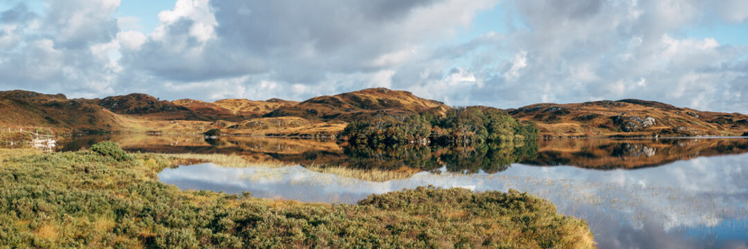 Reflections on Loch na Claise Fe&radic;&dagger;rne at sunrise. Highlands, Sco