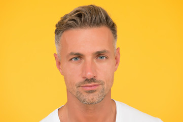 Skincare is essential. Handsome man yellow background. Caucasian guy with normal skin and facial...