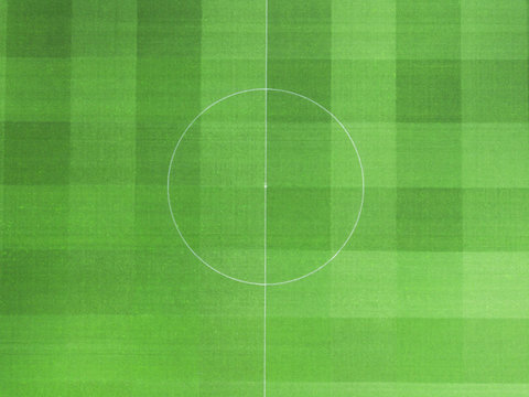Green grass pattern of soccer field from above.