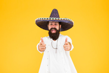 Fest and holiday. Celebrate traditions. hipster looks festive in sombrero. celebrating fiesta. happy man wear poncho. having fun on mexican party. sombrero party man. man in mexican sombrero hat © be free
