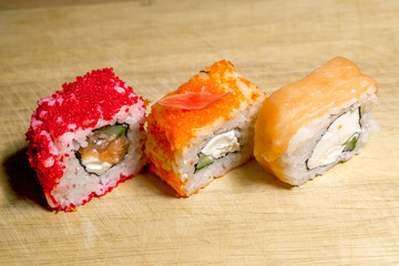 A set of  sushi neatly laid out on a wooden surface