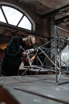 Man working with metal frame