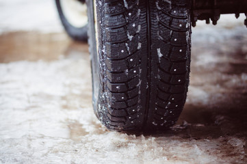 Fototapeta na wymiar winter tires on melted ice