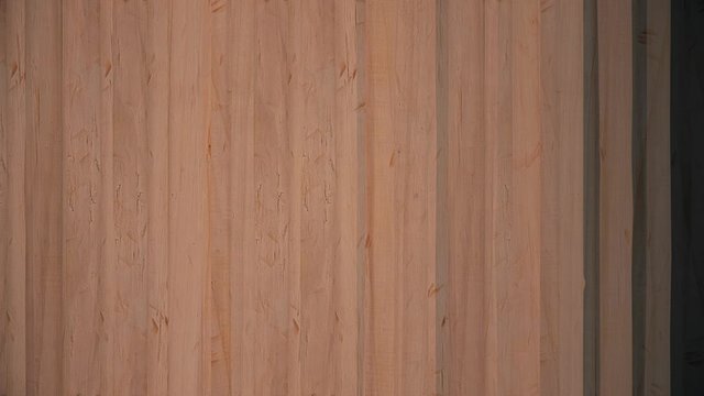 Abstract wooden planks appear on black background and forming the fence. Animation. Moving abstract background similar to the wooden fence from boards.