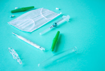 medical items, a thermometer, a white mask, an ampoule, a disposable syringe and pipettes for...