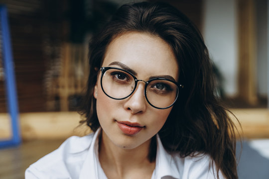 Portrait of happy woman wearing eyeglasses and looking at camera